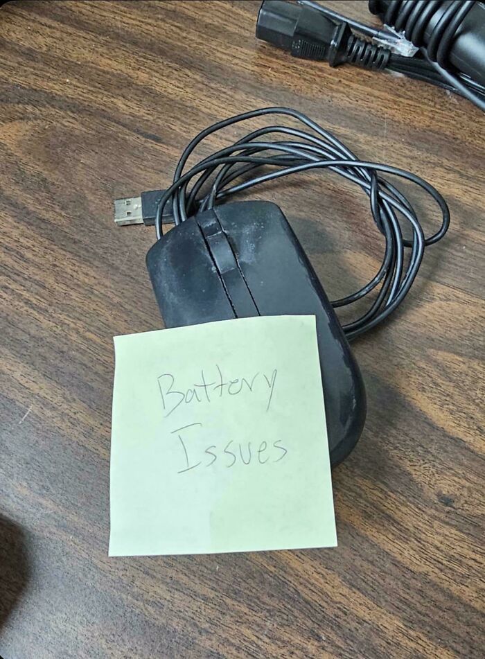 A computer mouse with a handwritten note saying Battery Issues, highlighting common electronics fails.