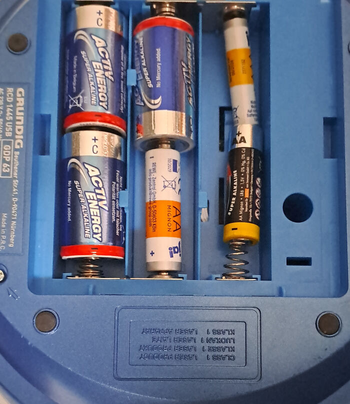 A close-up of battery installation in electronics showing several improperly inserted batteries, an example of electronics fails.