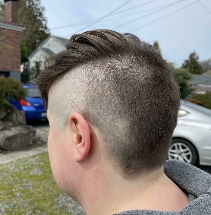 The back of a head with a very poorly executed fade haircut, a hair salon disaster.