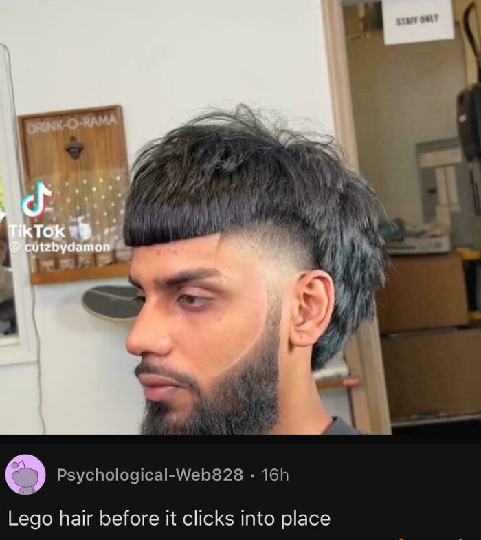 A man with a hair salon disaster, a bizarre haircut resembling a Lego hairstyle, with a beard fade.