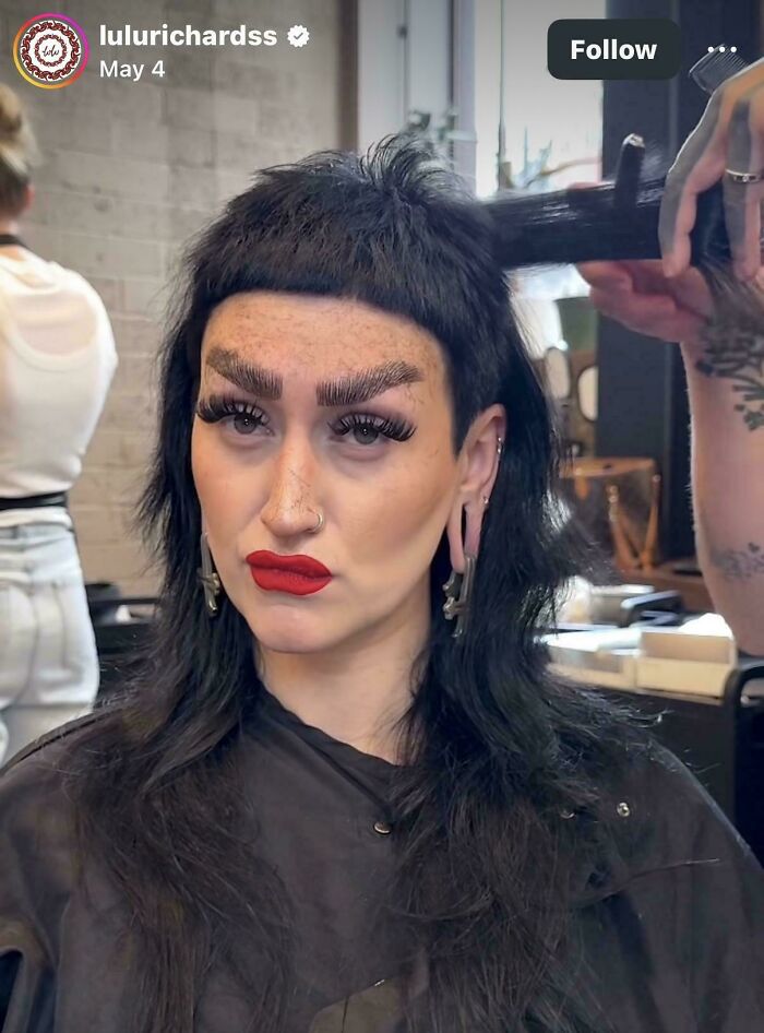 A woman with an extreme, short-bang hairstyle and bold makeup at a hair salon, portraying a hair salon disaster.
