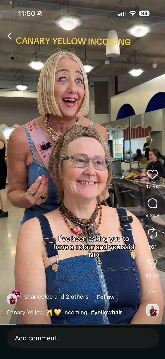 Two women at a hair salon, one excitedly gesturing towards the other, who has a smile, illustrating a hair salon disaster.