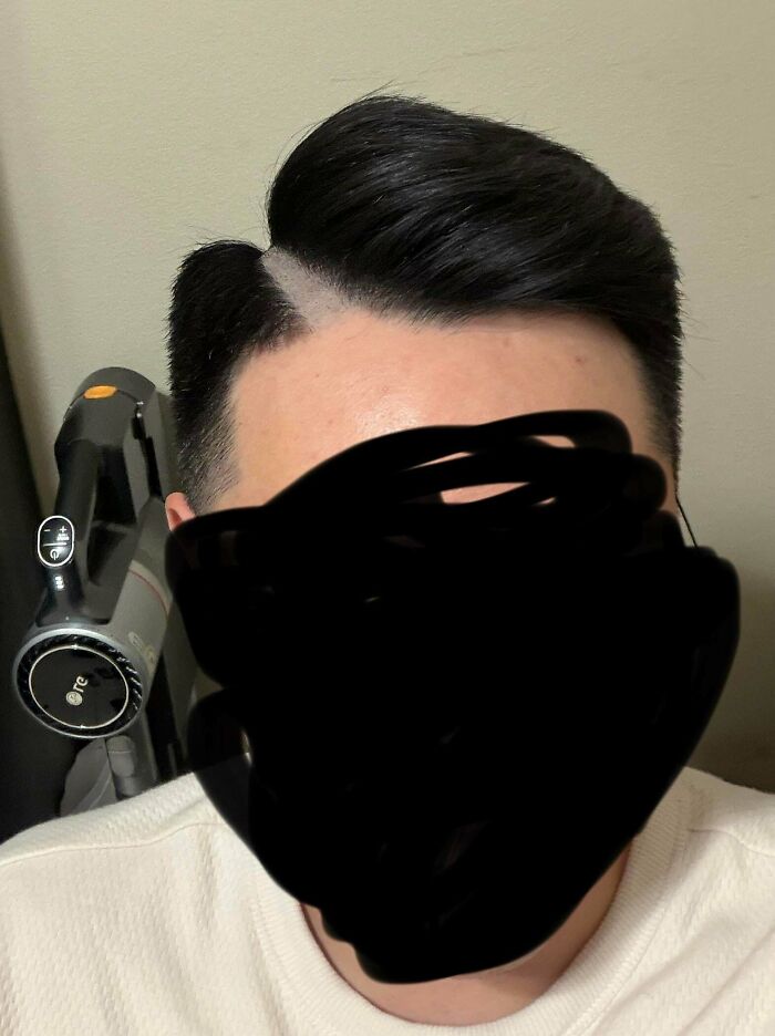 Man with a sharp side part and fade, illustrating a hair salon disaster.
