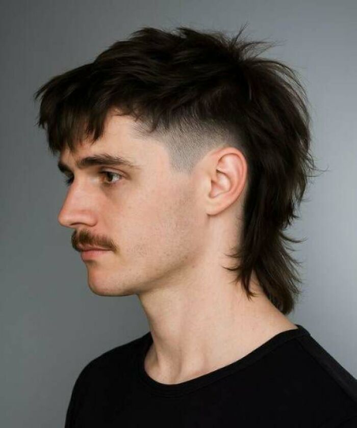 A man with a poorly executed mullet haircut, exemplifying a hair salon disaster.