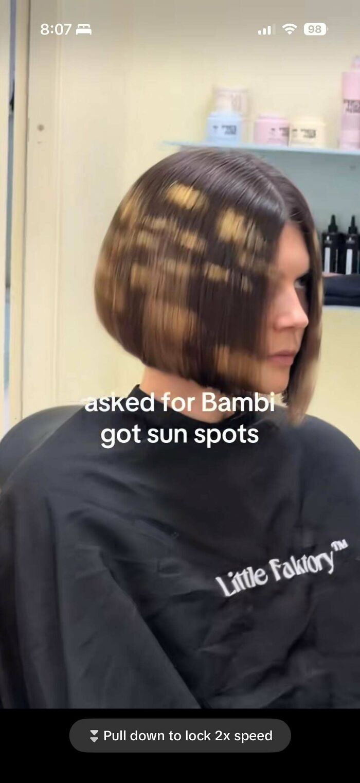 A person with a bob haircut featuring uneven blonde patches, showcasing a hair salon disaster.