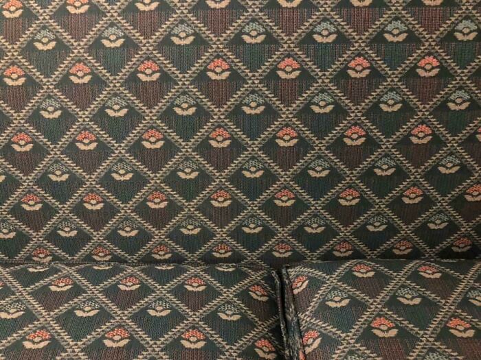A close-up of a couch with an intricate patterned fabric, appealing to an interior designer.