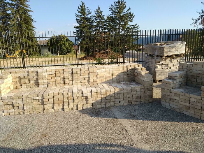 Couches made of stacked bricks form an outdoor seating area. An interior designer might find these unique couches interesting.