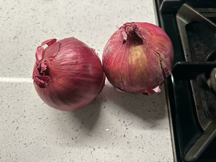 Two red onions on a kitchen counter, representing a disappointing food delivery fail when ordering something else.