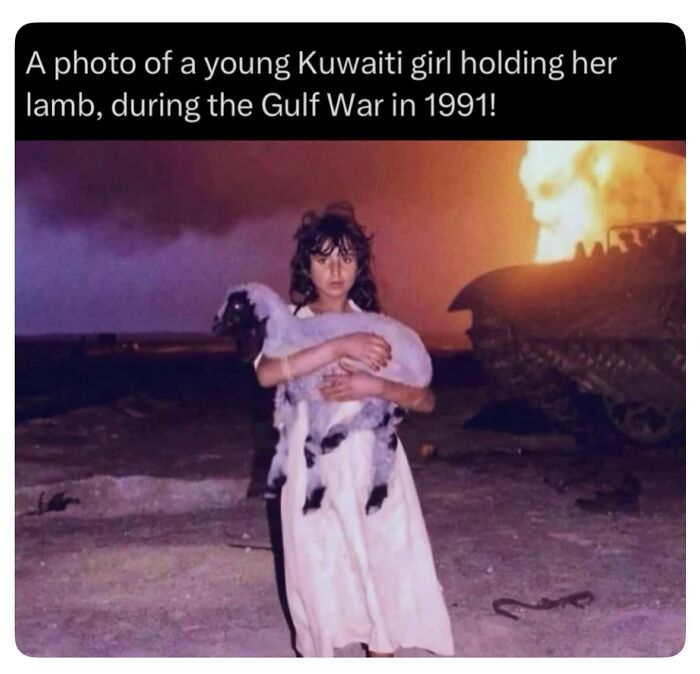 A young Kuwaiti girl holding a lamb during the Gulf War, with a burning oil field in the background, explaining all wars.