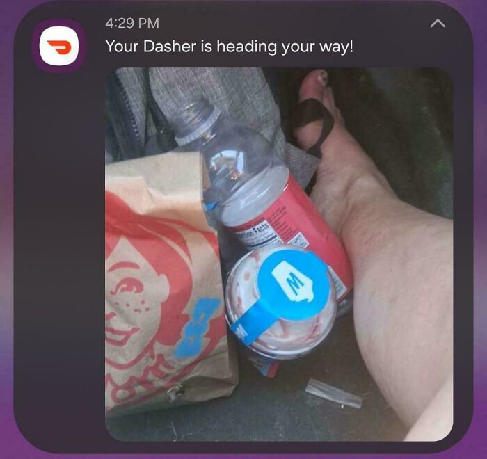 A photo from a food delivery driver showing a soda and a Frosty in a car, highlighting a potential food delivery fail.