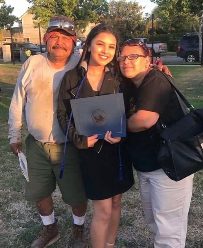 A graduating daughter with her proud parents, an amazing father and mother celebrating her achievement.