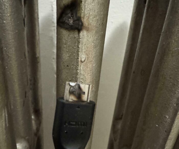 Burned electronics cable with melted USB port showing significant electronics fails.