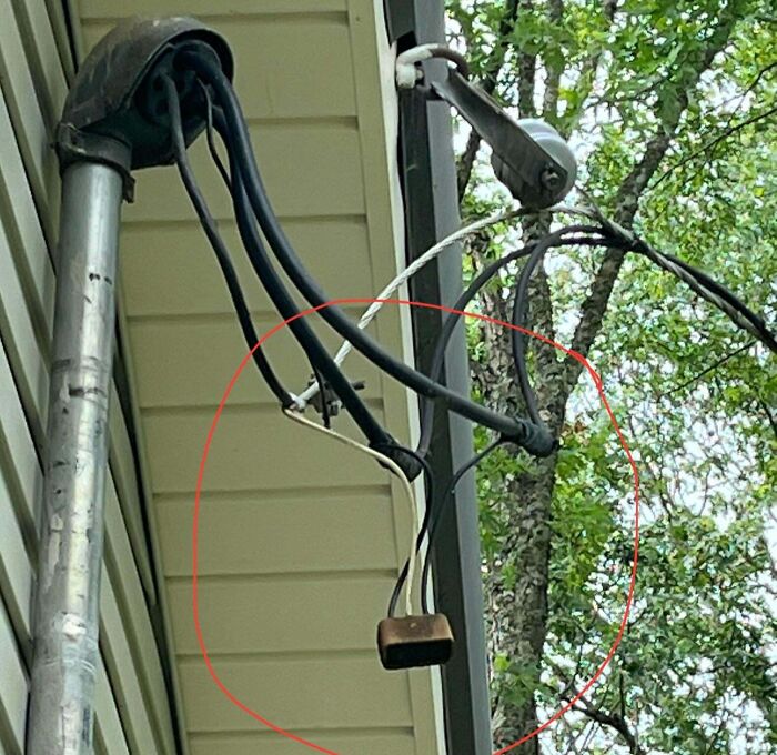 An outdoor electrical junction box with a loose connection, showcasing potential electronics fails.