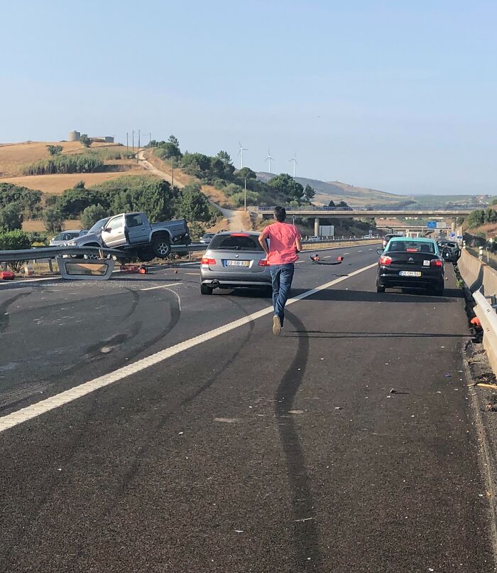 Man running on a highway after a multi-car accident, highlighting the protective instincts of amazing fathers.