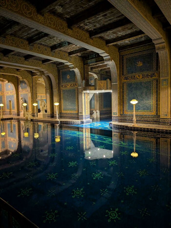 An elaborate indoor pool with ornate blue and gold mosaic tiles, an unsettling and deep liminal space.