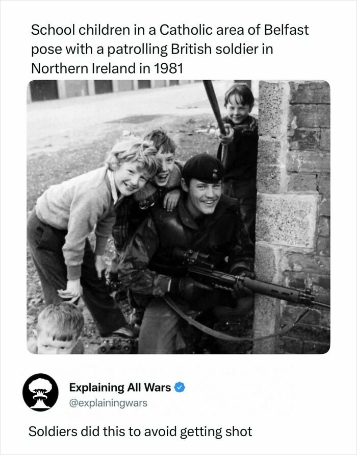 Historical image of school children posing with a British soldier, showing human interaction during all wars.