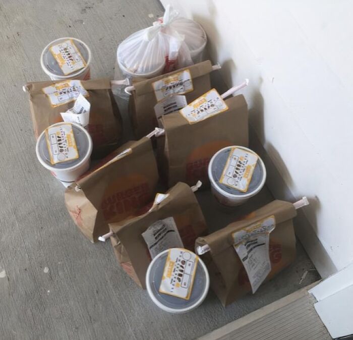 Multiple food delivery bags and drinks piled up, possibly a funny or infuriating scenario.