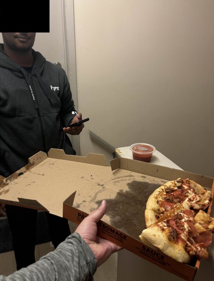 A person receiving a pizza box with only a few slices left, a funny food delivery fail that might inspire home cooking.