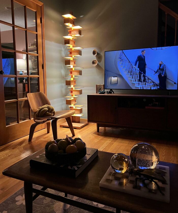 A cozy living room with a unique wooden lamp, reflecting amazing fathers and their comfortable homes.