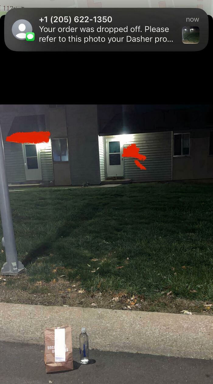 A food delivery bag and bottle left on a grassy area far from the house, a funny food delivery fail.