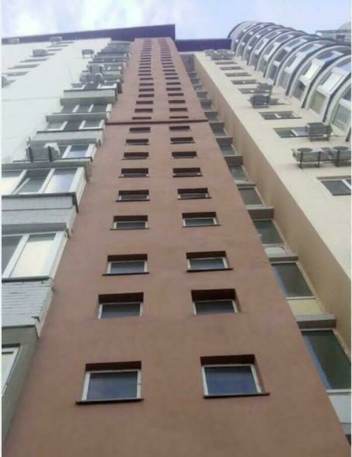 Funny fails: A tall building with an unusually narrow section, suggesting a construction error.