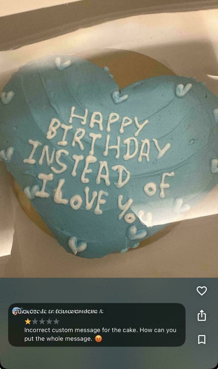 Funny fails: A heart-shaped cookie with blue frosting, incorrectly inscribed with Happy Birthday Instead of I Love You.