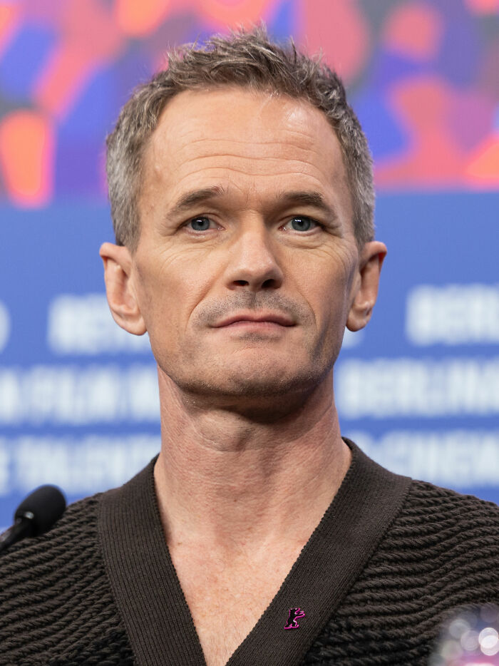 Close-up portrait of Neil Patrick Harris at a press event, highlighting his career and bio
