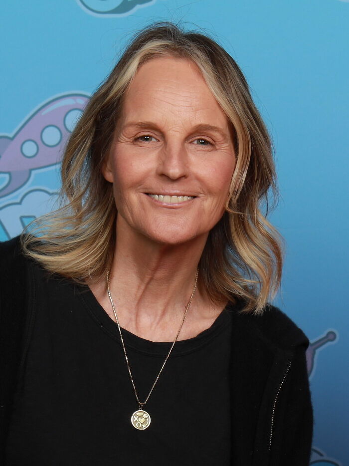 Portrait of Helen Hunt smiling against a blue backdrop highlighting her bio and career