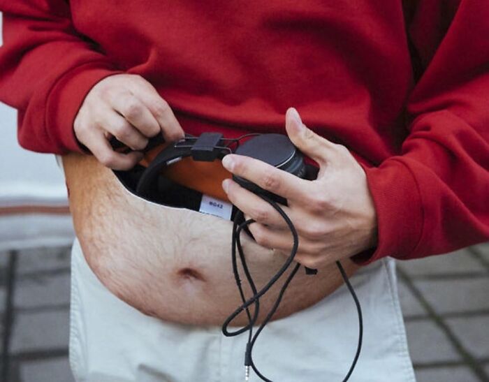 Funny dad gift with fake hairy belly pouch holding headphones