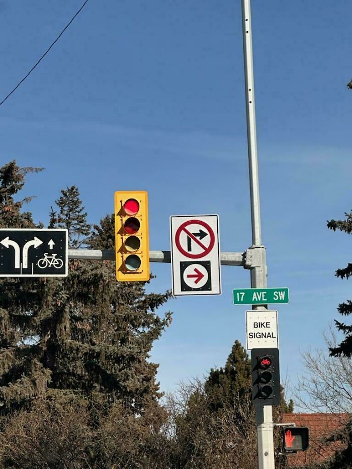 Traffic lights and bike signal with street signs on a clear day