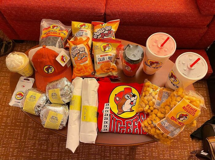 Table filled with Buc-ee's branded snacks, drinks, and merchandise