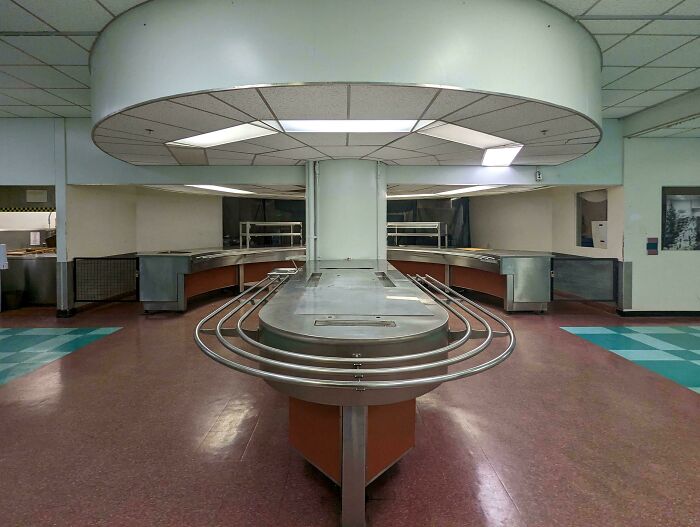 Empty cafeteria food court, an unsettling liminal space.