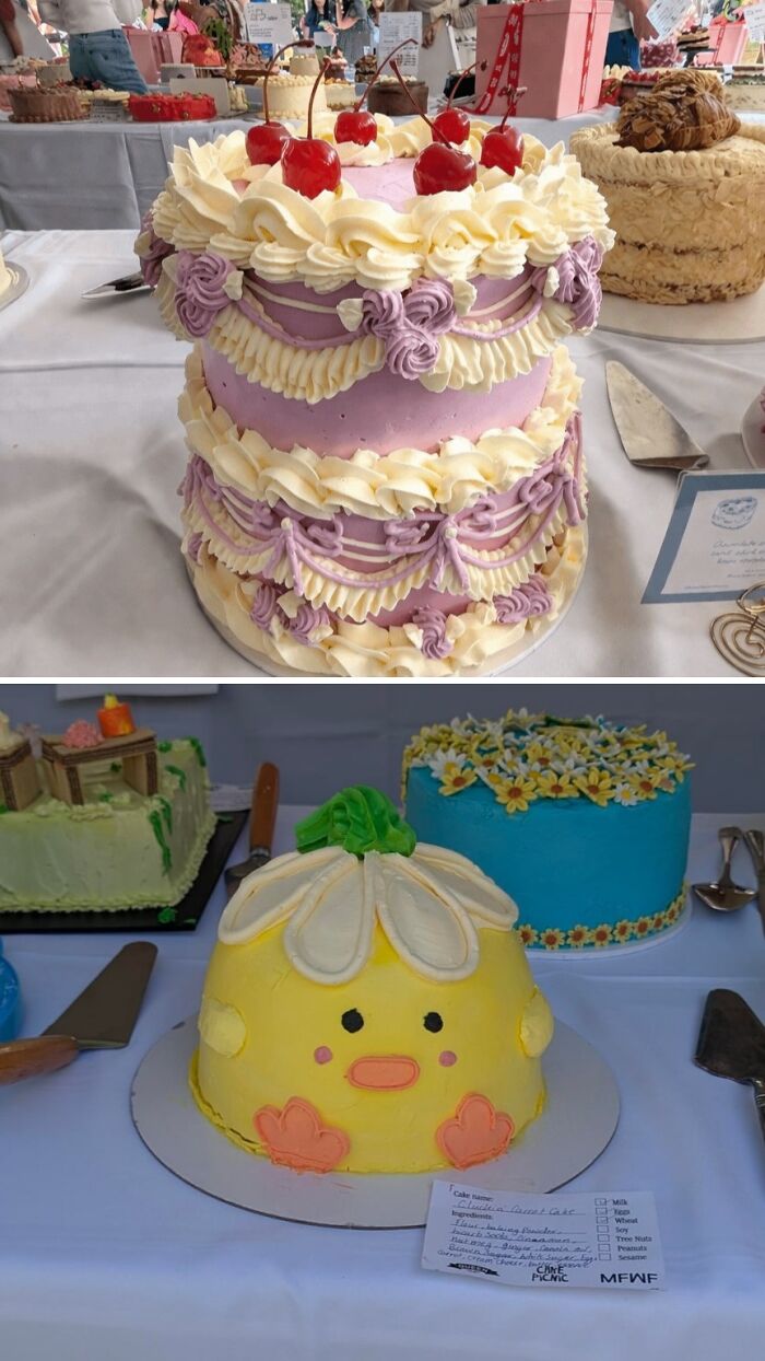 Purple and white layered cake decorated with cherries and cream swirls