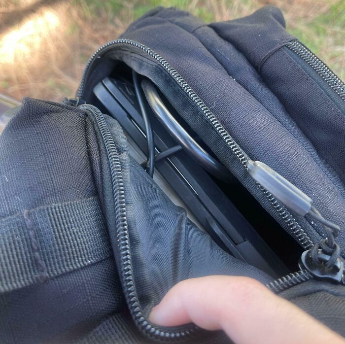 Backpack That Has Zippers On The Bottom Leading To The Main Bag That Open Up Automatically When You Put Too Much In