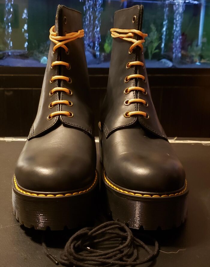 Find Prime Day Deals on stylish footwear like black platform boots with bright orange laces, an edgy fashion statement.