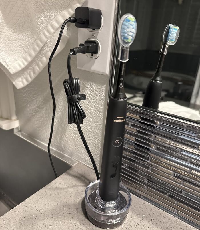Explore Prime Day Deals for personal care with a Philips Sonicare toothbrush charging in a bathroom, promoting oral hygiene.