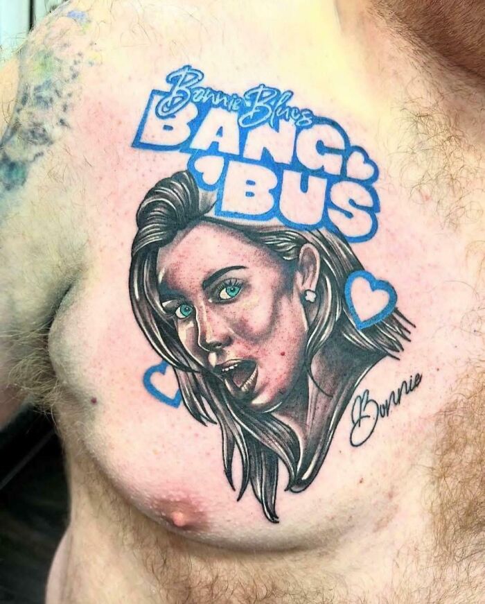 Tattoo portrait with text and hearts on chest with awkward look