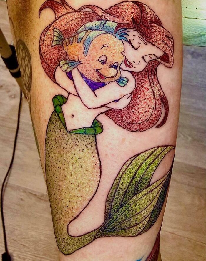 Poorly drawn mermaid and fish tattoo with bright colors tattoo fails