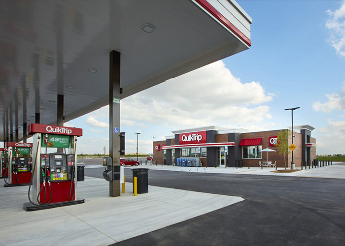 QuikTrip gas station exterior with pumps and convenience store under clear sky QuikTrip gas station exterior with pumps and convenience store under clear sky