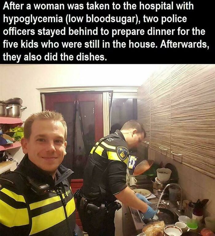 Two police officers showing strength by helping by cooking and doing dishes for children.
