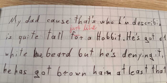 A notebook page showing student handwriting with a teacher's red corrections on an essay about a dad, highlighting a toxic teacher.