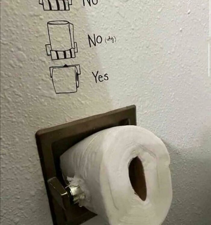 A toilet paper roll inserted incorrectly into a holder, a mad lad move, challenging the rules of proper placement.