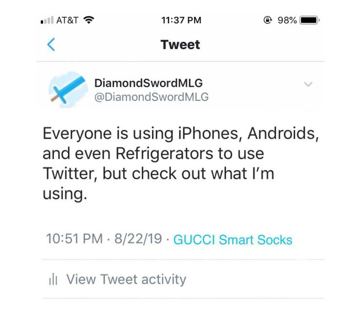 A tweet from a mad lad, showing that he is using GUCCI Smart Socks to use Twitter.