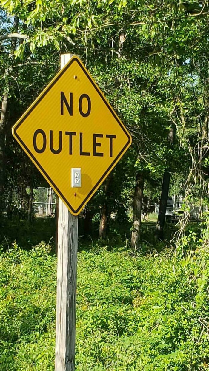 A No Outlet sign has an electrical outlet installed on the pole, an act of Mad Lads.