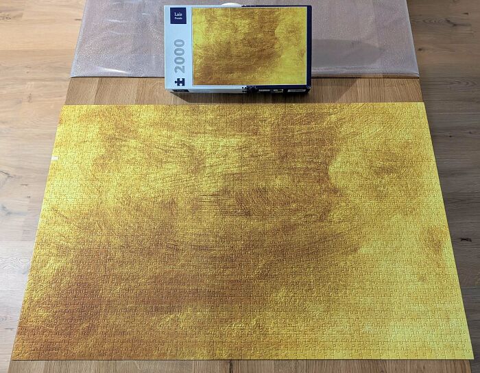 An image of a completed jigsaw puzzle, showcasing a large golden abstract brain puzzle, still life.