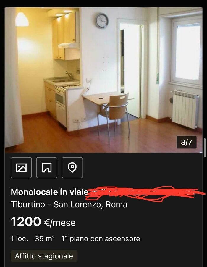 A tiny studio apartment with a compact kitchen and small dining table, an unhinged real estate listing.