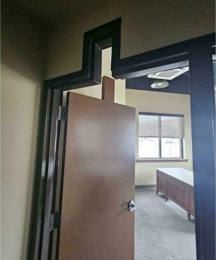 An unhinged real estate listing showcasing a uniquely shaped doorway with an unusual, jagged frame design leading into an office space.