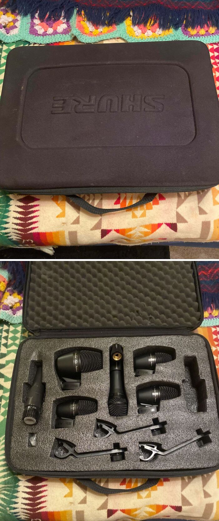 A black Shure case found dumpster diving, revealing a set of microphones and accessories inside cushioned foam.