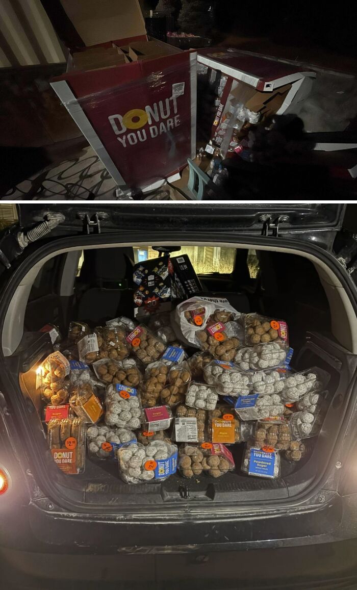 Numerous packages of donuts filling a car trunk, an abundant haul from dumpster diving.