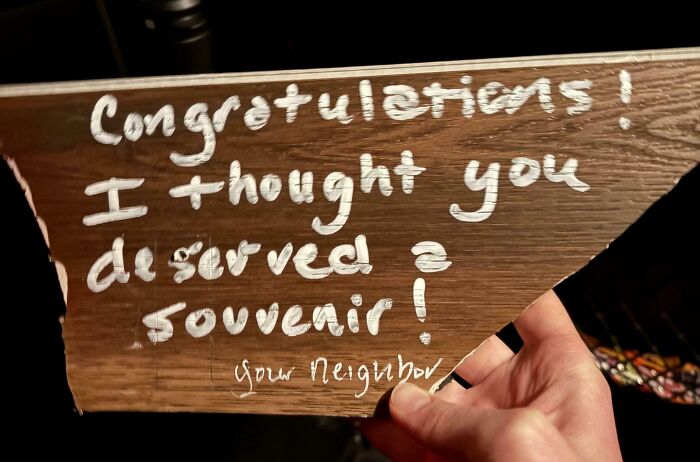 A funny neighbor note written on a piece of wood, reading Congratulations! I thought you deserved a souvenir!
